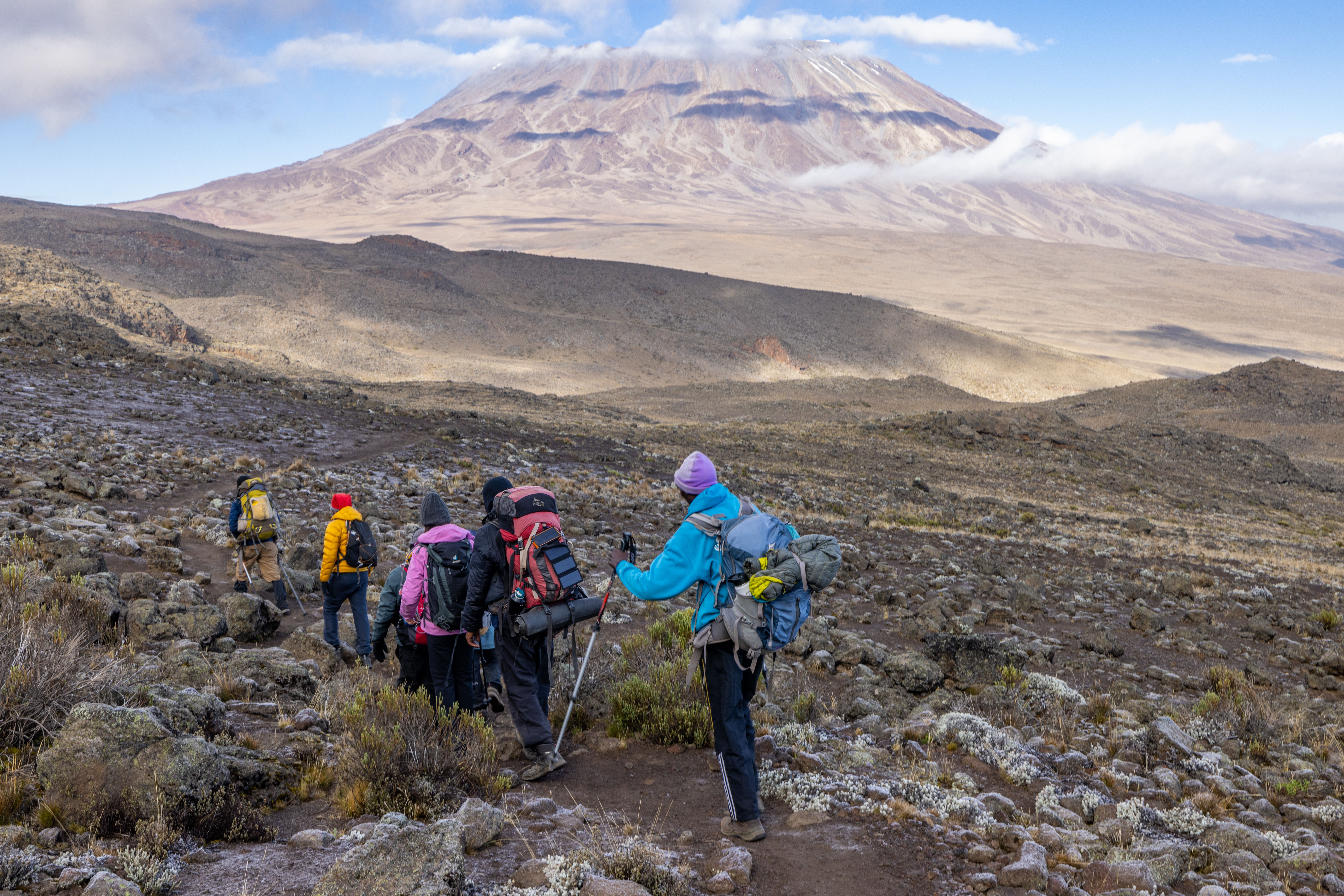 A group of hikers on a rocky terrain.