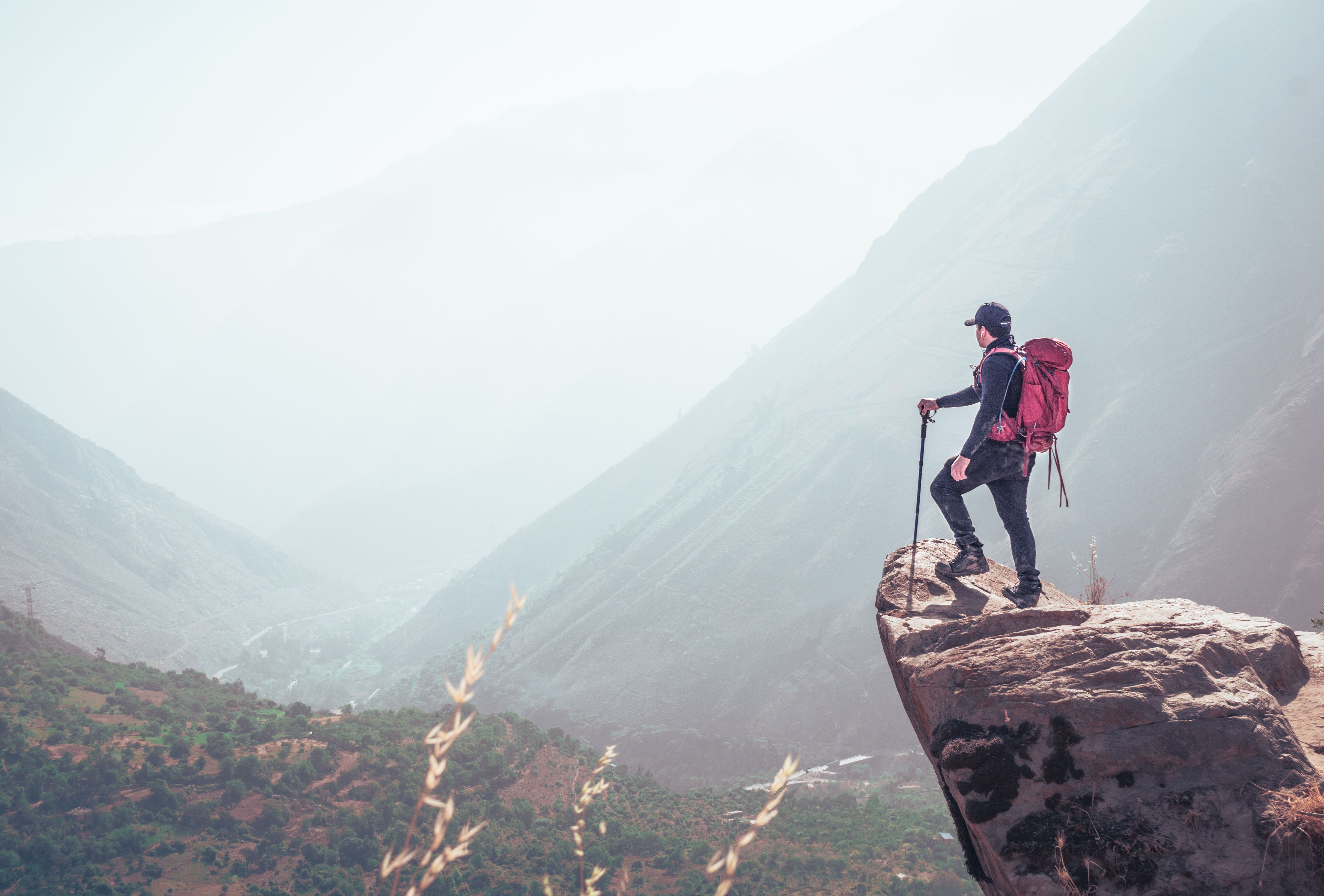 A mountaineer standing on the edge of a cliff.
