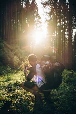 A backpacker taking a photograph