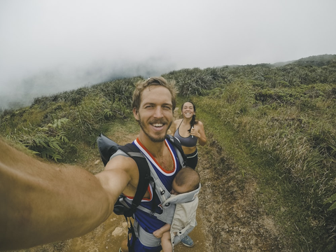 A couple with a baby on a trail