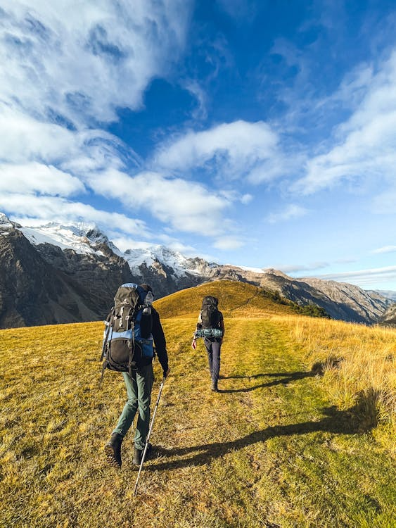 people hiking on a mountainous trail