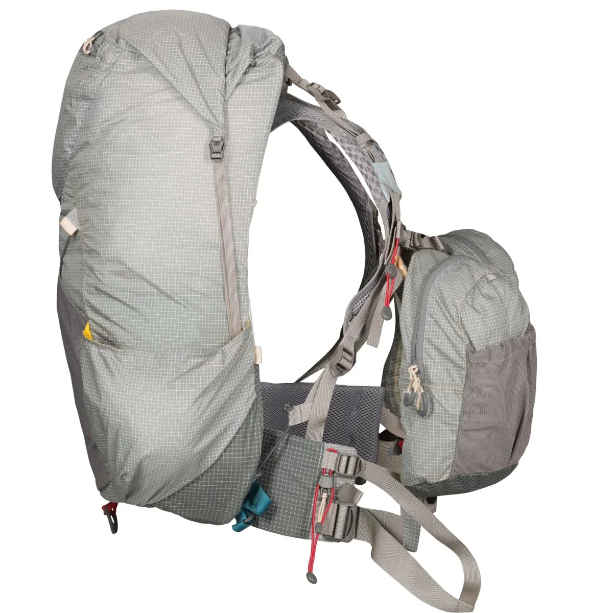 Gray backpack shown from the side with front zippered pocket, padded hip belt, and multiple adjustment straps