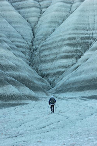 a man standing in front of a mountain