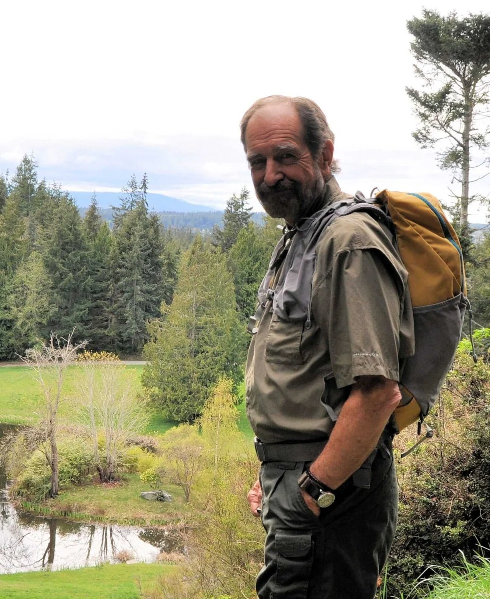 An image shows a man wearing a 20 Liter Aarn Little Llama Backpack standing outdoors.