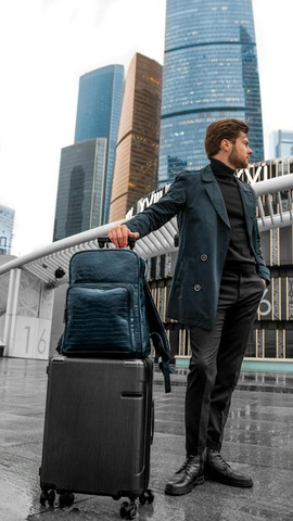 Man wearing a blue coat and carrying a backpack