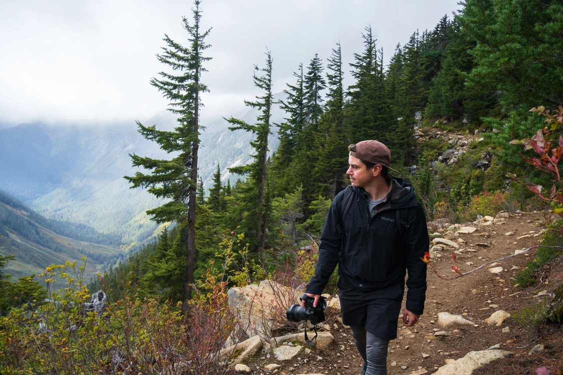 Hiker exploring a Pacific Northwest mountain trail while preparing for a wilderness trek with the right gear.