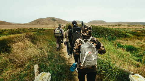 People are walking on a trail.