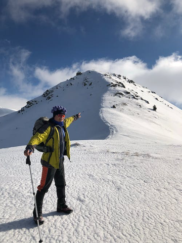 a person pointing to the mountain