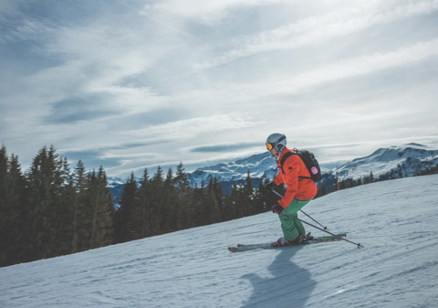 Person wearing a backpack while skiing.