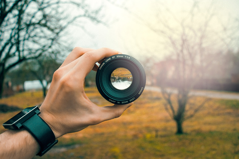 A hiker holding his camera lens
